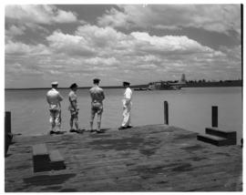 Vaal Dam, circa 1949. Arrival of BOAC flying boat Solent G-AKNS. Men on jetty with aircraft in th...