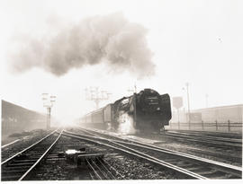 Bloemfontein, 1954. SAR Class 15F with main line passenger train arriving at station.