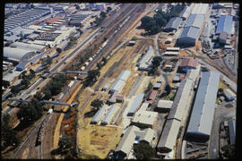 
Aerial view of railway line running through industrial area.
