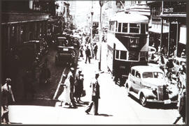 City street with motors, trams and pedestrians.
