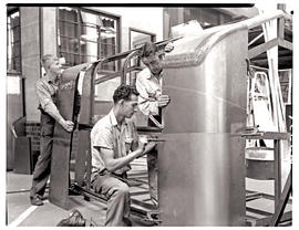 "Johannesburg, 1962. Apprentices fitting sheetmetal panel to coach body in Road Transport Se...