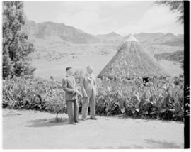 Royal Natal National Park, Drakensberg, 14 to 16 March 1947. Two unidentified men beside thatched...