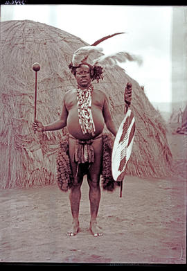 "Eshowe district, 1929. Zulus warrior in front of hut."