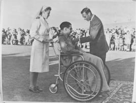 Johannesburg, 5 April 1947. King George VI speaks to a man confined to a wheelchair at the Baragw...