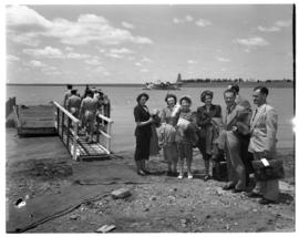 Vaal Dam, circa 1949. Arrival of BOAC flying boat Solent G-AKNS. Passengers next to jetty.