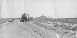 Cypress Grove, 1895. Engine taking water with station building in distance. (EH Short)