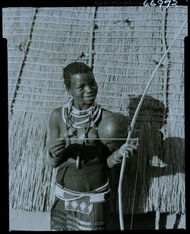 Zululand, 1957. Zulu girl with musical instrument.