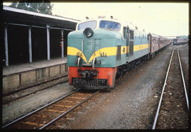 Mafeking, 1980. RR Class DE2 with passenger train at station platform.
