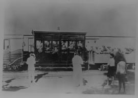 Okiep - Port Nolloth narrow gauge railway. 1st class coach and open passenger wagon at station bu...