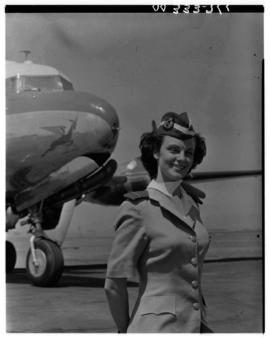 September 1952. Miss Badenhorst, air hostess, at nose of SAA Douglas DC-4 Skymaster.