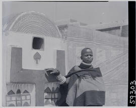 Pretoria district, 1952. Ndebele woman at decorated wall.