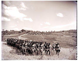 Zululand, 1951. Large group of Zulu girls with kraal in the distance.