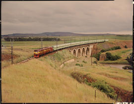 Balfour district, 1974. Drakensberg Express on concrete arch bridge.