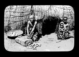 Three black people at traditional home.