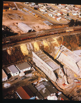 Construction of double-track railway embankment over two concrete underpasses.