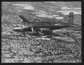 Johannesburg. SAA Douglas DC-4 ZS-AUB 'Outeniqua' in flight. Note flying springbok roundel.