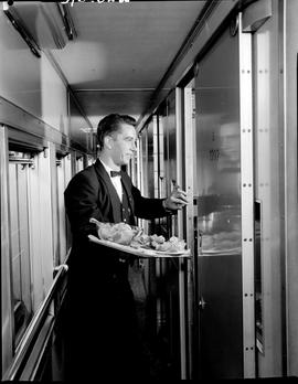 July 1965. Waiter in train corridor.
