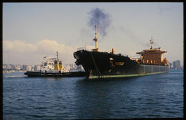 Durban, 1983. SAR tug 'W Marshall Clark' with ship in Durban Harbour.