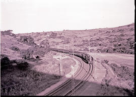 Durban, 1938. Two SAR Class 1E's in cutting near Mariannhill with main line passenger train.