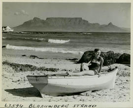 Cape Town, 1955. Girl on boat at Bloubergstrand with Table Mountain in the background.