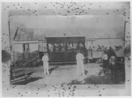 Okiep - Port Nolloth narrow gauge railway. 1st class coach and open passenger wagon at station bu...
