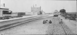 Swartkops, 1895. Goods wagon in station with small boys playing on railway line, viewed towards t...