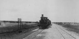 Koedoe, 1895. CGR 1st Class of 1879 with train in station. (EH Short)