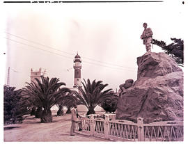 Swakopmund, South-West Africa, 1952. Herero war memorial with lighthouse in the distance.