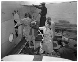 Vaal Dam, November 1949. BOAC Solent G-AHIX 'City of Edinburgh'. Hostess assisting passenger onto...