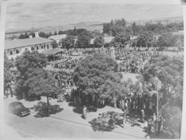 
Aerial view of gathering to greet Royal Family in a town square.
