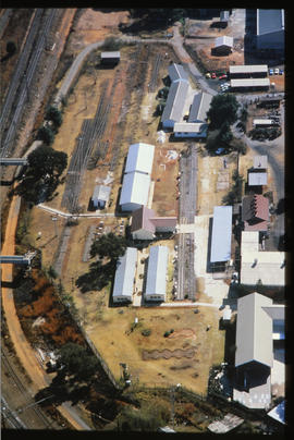 
Aerial view of railway line running through industrial area.
