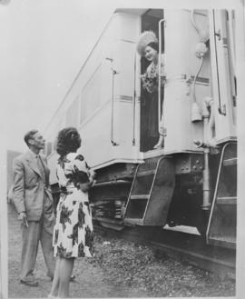 
Queen Elizabeth in Royal Train, King George VI and another woman outside train below.
