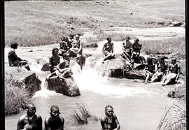 Zululand, 1933. Zulu bridal party of young women on rocks in a river.