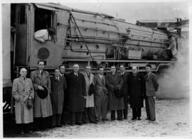 SAR Class 25NC No 3412 with group of men posing, snow on the ground.