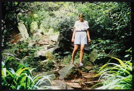
Woman hiking in forest.
