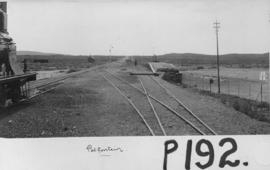 Potfontein, 1895. Railway lines with Cape 3rd Class built 1889 on the left and loading platform i...
