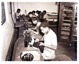 "Aliwal North, 1952. Roman Catholic trade school interior, pupils working with sewing machin...
