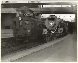 Johannesburg, 1939. SAR Class 23 No 3214 with Union Limited in station with SAR type 2M1 EMU alon...