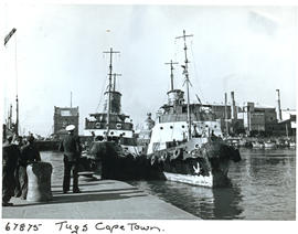 "Cape Town, 1957. Harbour tug 'FT Bates' manoeuvred into dry dock by harbour tug 'TH Waterme...
