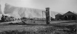Graaff-Reinet, 1895. Water column with Cape 4th Class Stephenson on train and locomotive shed in ...