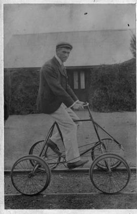 Springfontein, 1902. Mr J Holmes CSAR Inspector on velocipede at station.