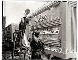 "Johannesburg, 1962. Two apprentices securing sign on container trailer at Road Transport Se...