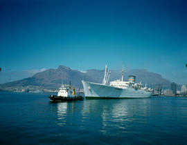 Cape Town. Tug 'JM Botha' leading 'SA Oranje' out of Table Bay Harbour. [D Dannhauser]