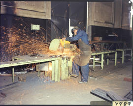 Cutting steel in workshop.