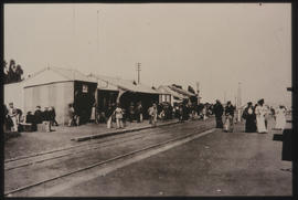 Passengers waiting on station platform.