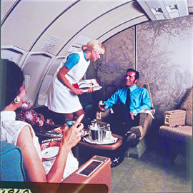 SAA Boeing 747 interior. Cabin service. Handing out magazines. First class. Hostess Isabel Barnard.