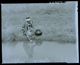 Zululand, 1957. Zulu woman fetching water at river.