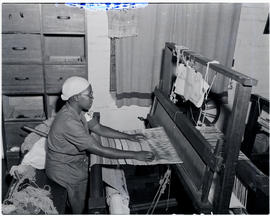 Pietermaritzburg, 1946. Woman weaving carpet on modern loom.