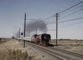 Bloemfontein district, 1984. SAR Class 26 No 3450 'Red Devil' with Drakensberg Express. [D Dannha...