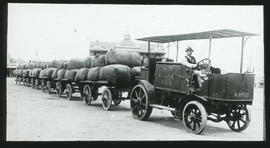 East London, circa 1916. SAR Dennis rubber-tyred tractor No R1501 with row of trailers with Grand...
